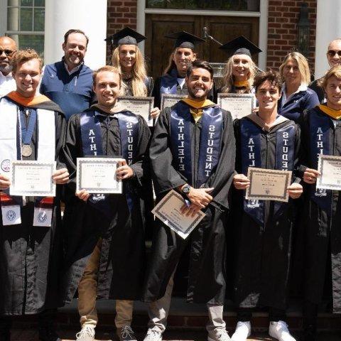 Graduating student athletes pose for a photo.