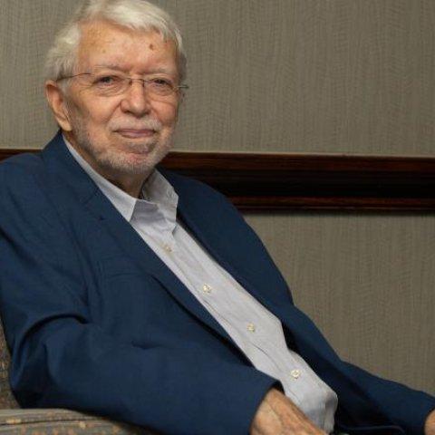 Wayne Talley, Ph.D., seated in a chair